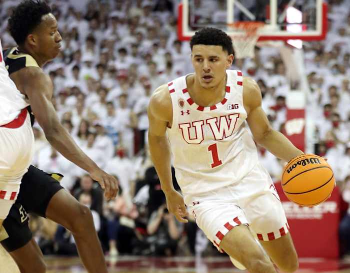 Wisconsin Badgers guard Johnny Davis (1) takes the ball past Purdue Boilermakers guard Eric Hunter Jr. (left) at the Kohl Center.